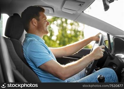 transport, vehicle and people concept - smiling man or driver driving car in summer. smiling man or driver driving car