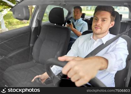 transport, vehicle and taxi concept - male driver driving car with passenger. male taxi driver driving car with passenger