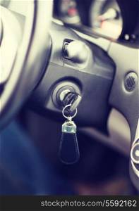 transportation and ownership concept - car key in ignition start lock