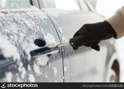 transportation and ownership concept - closeup of man hand opening car with key
