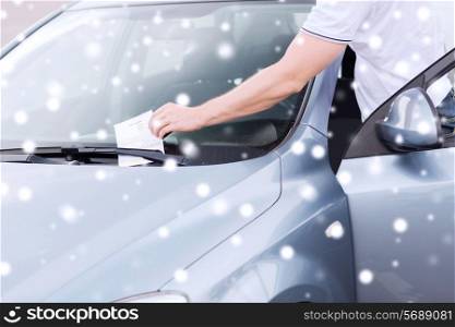 transportation and vehicle concept - close up of parking ticket on car windscreen