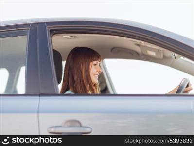 transportation and vehicle concept - happy woman driving a car