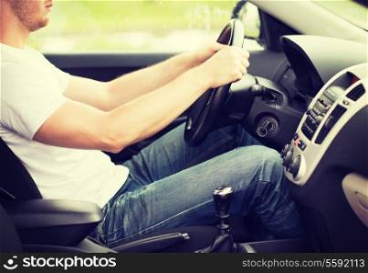transportation and vehicle concept - man driving the car with manual gearbox