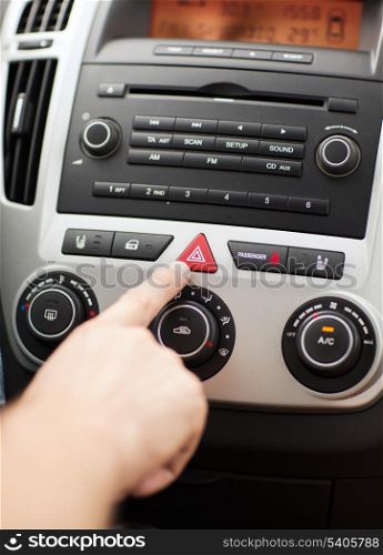 transportation and vehicle concept - man pressing red triangle car hazard warning button