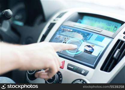 transportation and vehicle concept - man using car control panel to read news