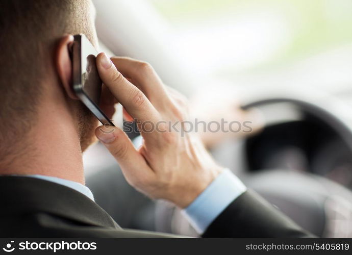 transportation and vehicle concept - man using phone while driving the car