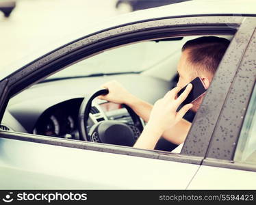 transportation and vehicle concept - man using phone while driving the car