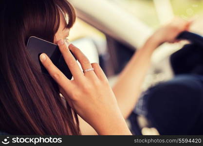 transportation and vehicle concept - woman using phone while driving the car