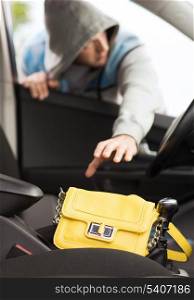 transportation, crime and ownership concept - thief stealing bag from the car