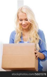 transportation, delivery, home and people concept - smiling woman opening cardboard box at home