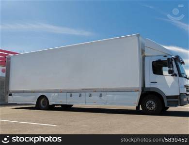 transportation, freight transport, advertisement and vehicle parts concept - truck on city parking