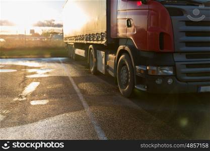 transportation, freight transport and vehicle concept - close up of truck on parking