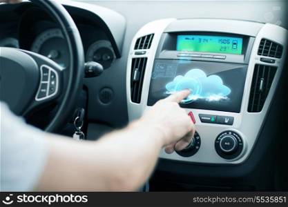 transportation, future technology and vehicle concept - man using car control panel
