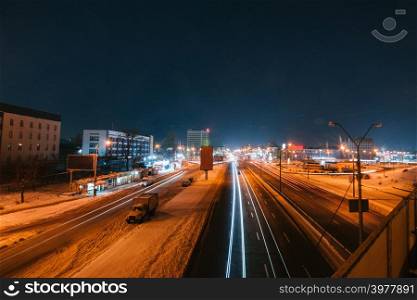 Transportation highway system with long exposure in dusk, shoted in Kyiv, Ukraine. Car trails on busy road.