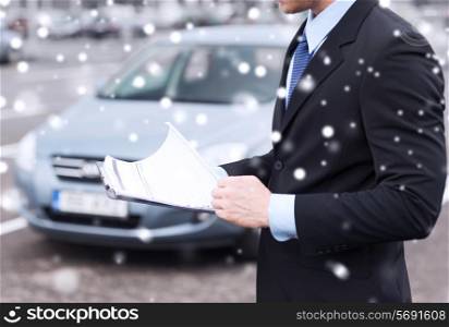 transportation, people, sale and ownership concept - close up of man with clipboard and car documents