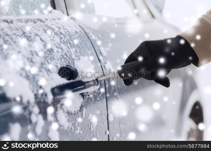 transportation, people, season and ownership concept - close up of man with car key outdoors