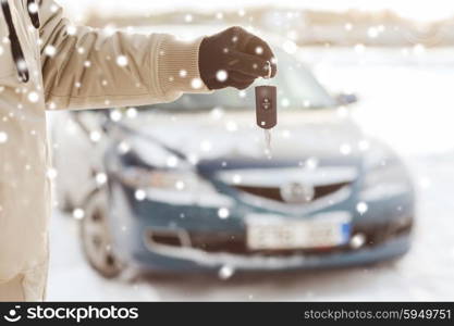 transportation, people, season and ownership concept - close up of man with car key outdoors