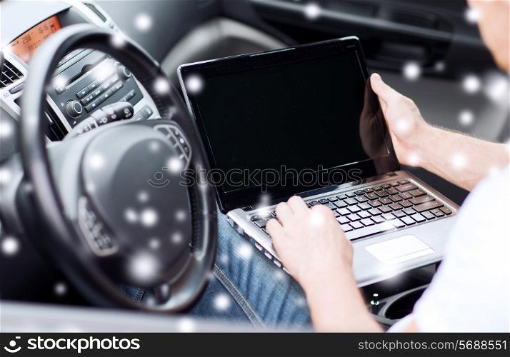 transportation, people, technology and vehicle concept - close up of man using laptop computer in car