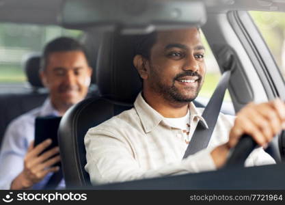 transportation, vehicle and people concept - happy smiling indian male driver driving car with passenger. indian male driver driving car with passenger