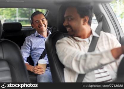 transportation, vehicle and people concept - happy smiling middle aged male passenger with coffee cup talking to taxi car driver. male passenger with coffee talking to car driver