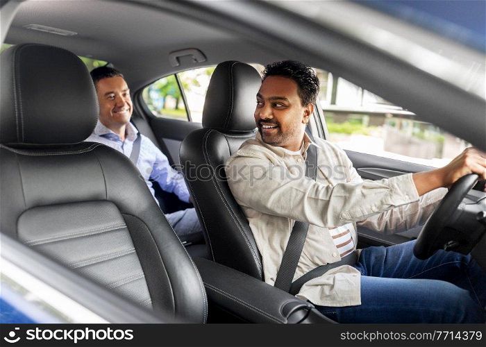 transportation, vehicle and people concept - happy smiling middle aged male passenger talking to taxi car driver. middle aged male passenger talking to car driver