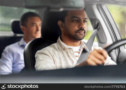 transportation, vehicle and people concept - indian male driver driving car with passenger. indian male driver driving car with passenger