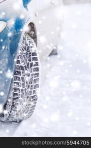 transportation, winter and vehicle concept - closeup of car wheel