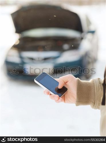 transportation, winter and vehicle concept - closeup of man with broken car and cell phone
