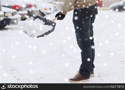 transportation, winter, people and vehicle concept - closeup of man digging snow with shovel near car