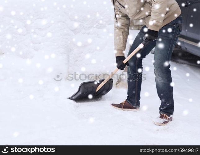 transportation, winter, people and vehicle concept - closeup of man digging snow with shovel near car