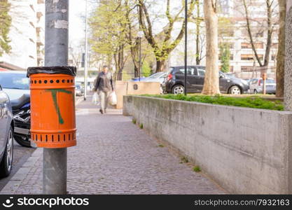 Trash orange metal for the collection of waste of the road