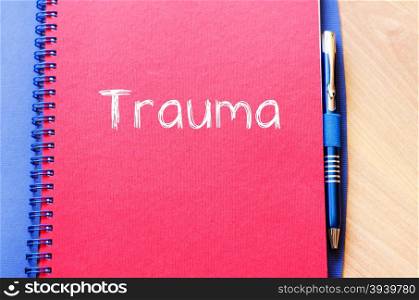 Trauma text concept write on notebook with pen