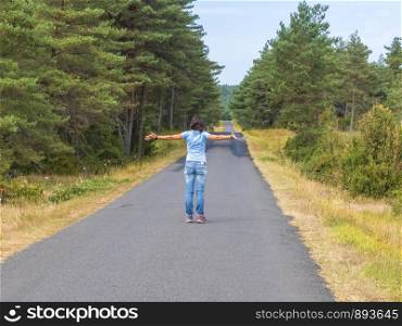 Travel adventure woman arms raised at view of road landscape on exploration discover beautiful earth.