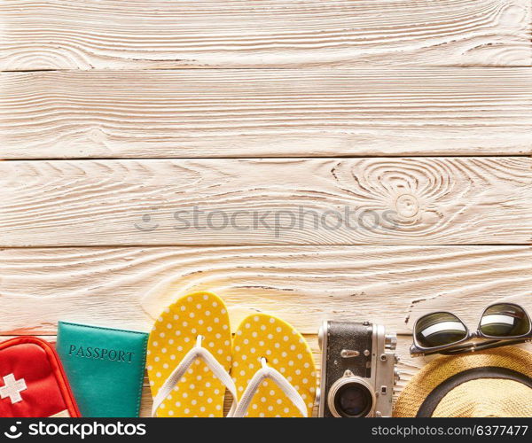 Travel and beach items still life over wooden background