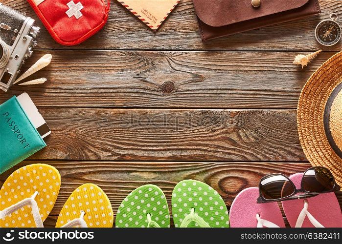 Travel and beach items still life over wooden background