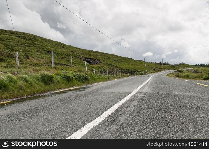 travel and countryside concept - asphalt road at connemara in ireland. asphalt road at connemara in ireland