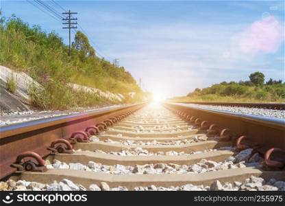 Travel and transportation background concept. Empty railway or railway tracks with blue sky at sunrise. Picture for add text message. Backdrop for design art work.