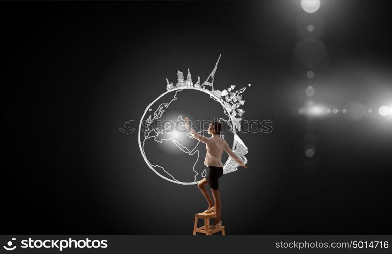 Travel and visit countries. Businesswoman standing on chair and reaching travel concept