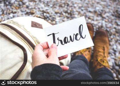 travel and weekend - inscription travel on a background of a backpack and trekking boots