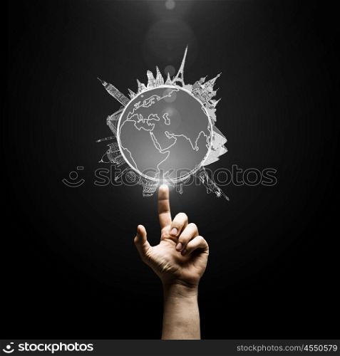 Travel around the world. Human hand pointing with finger on Earth planet