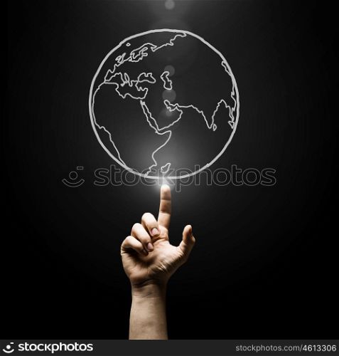 Travel around the world. Human hand pointing with finger on Earth planet