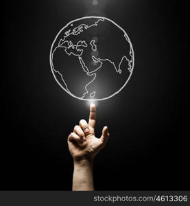 Travel around the world. Human hand pointing with finger on Earth planet