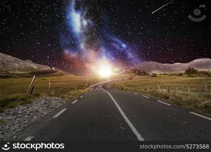 travel, astronomy and landscape concept - asphalt road over night sky or space with shooting stars background. asphalt road over night sky or space