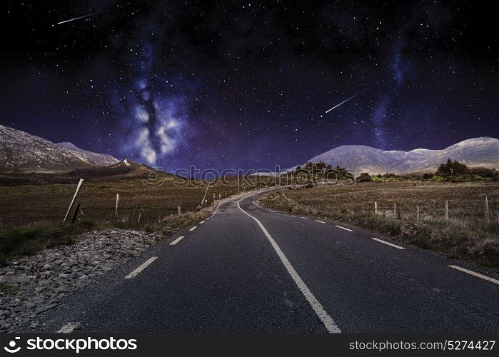 travel, astronomy and landscape concept - asphalt road over night sky or space with shooting stars background. asphalt road over night sky or space