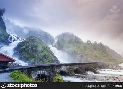 Travel attraction. Powerful twin waterfall Latefoss or Latefossen and six arched bridge along Route 13, Odda Hordaland County in Norway.. Latefossen waterfall in Norway