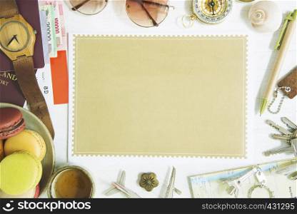 Travel background concept from free space brown paper put on table with accessories, passport, money, sunglasses, compass, pen, tag, clock, map, airplane model, tea cup and macaroons desert.