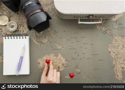 travel background with hand placing heart australia