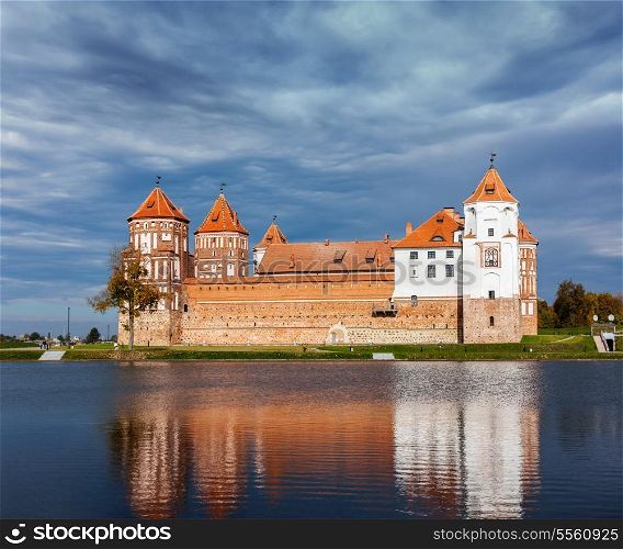 Travel belarus background - Medieval Mir castle famous landmark in town Mir, Belarus reflecting in lake