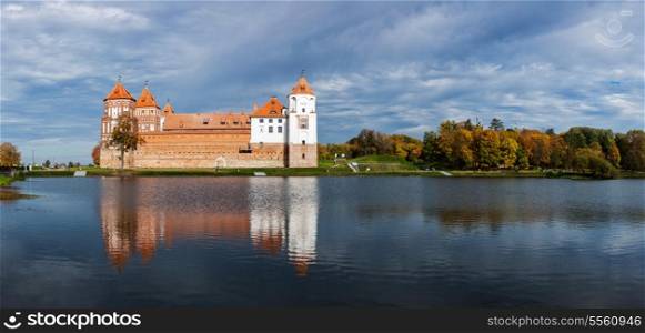 Travel belarus background - Medieval Mir castle famous landmark in town Mir, Belarus reflecting in lake