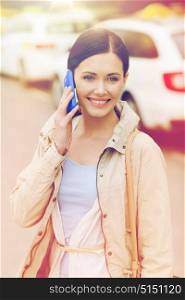 travel, business trip, people and tourism concept - smiling young woman calling and talking on smartphone over taxi station or city street. smiling woman with smartphone over taxi in city